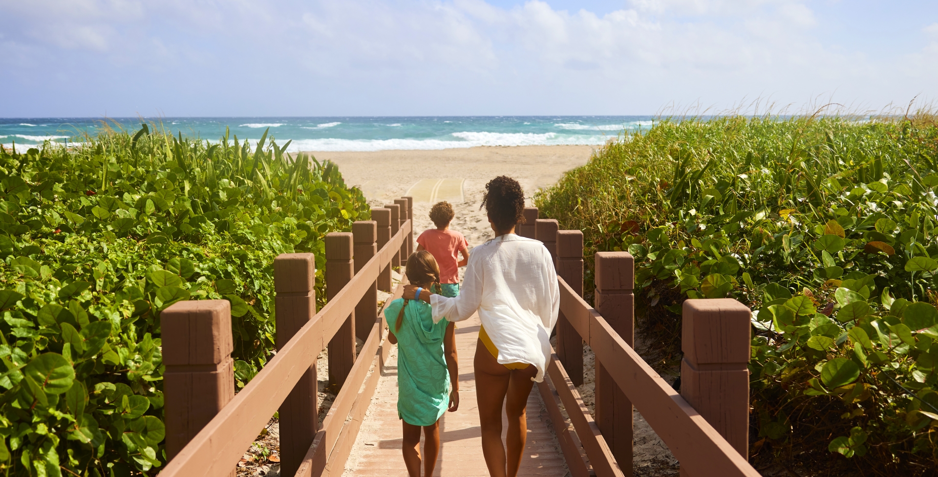 family walking towards the beach on singer island